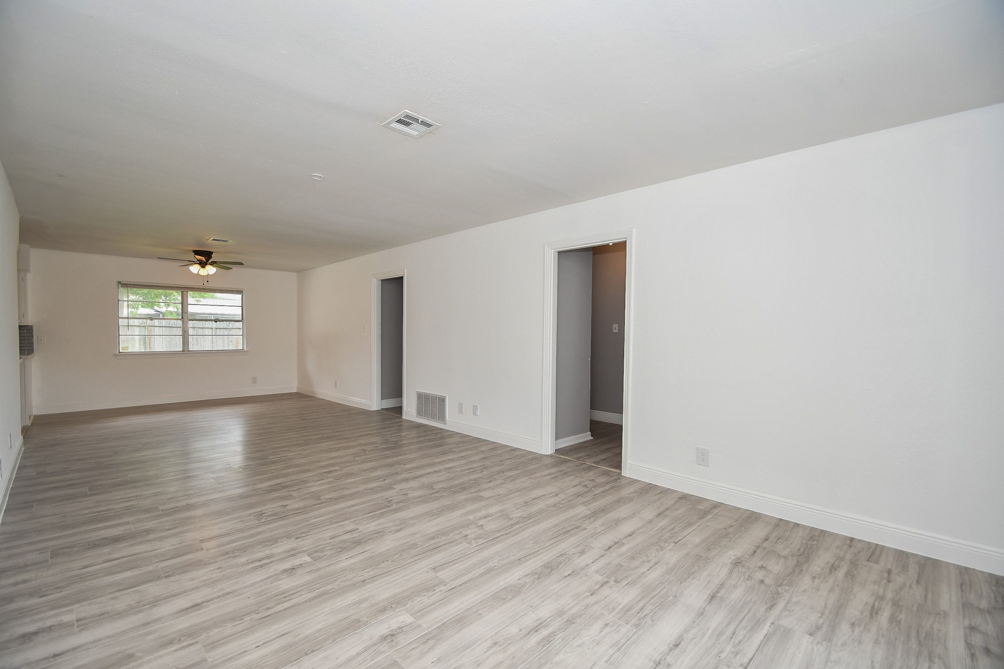 5330 Windswept Lane Houston, TX 77056 - Photo 2 of 20 an empty room with wooden floor and windows