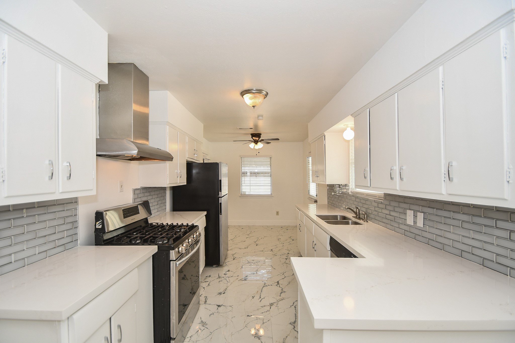 5330 Windswept Lane Houston, TX 77056 - Photo 4 of 20 a kitchen with stainless steel appliances granite countertop a sink stove and refrigerator