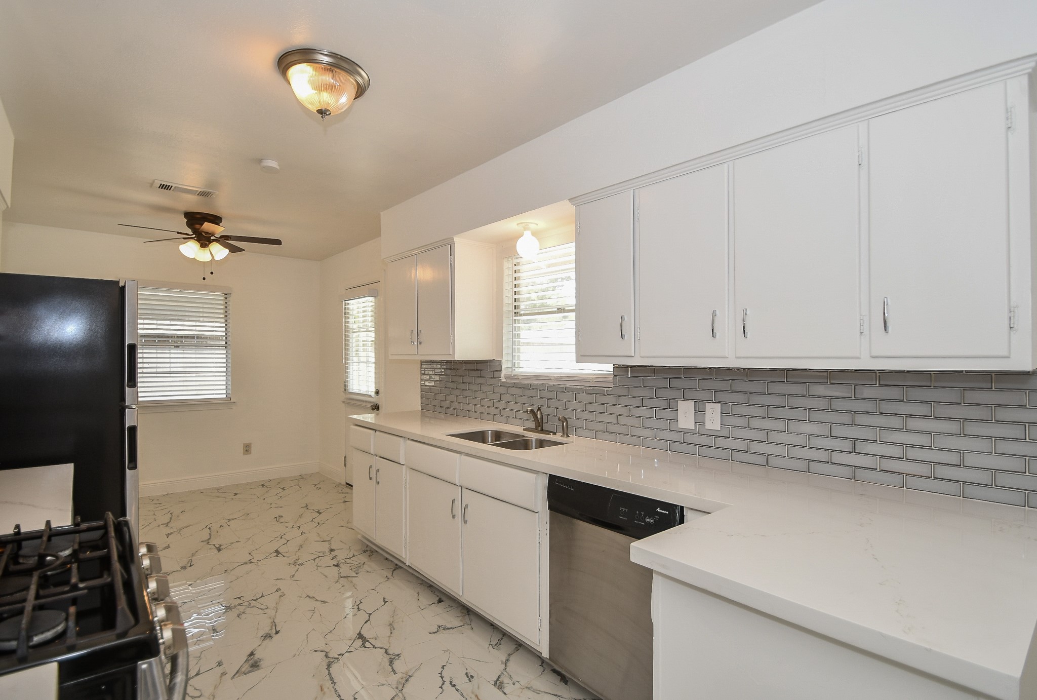 5330 Windswept Lane Houston, TX 77056 - Photo 5 of 20 a kitchen with a sink stove and cabinets