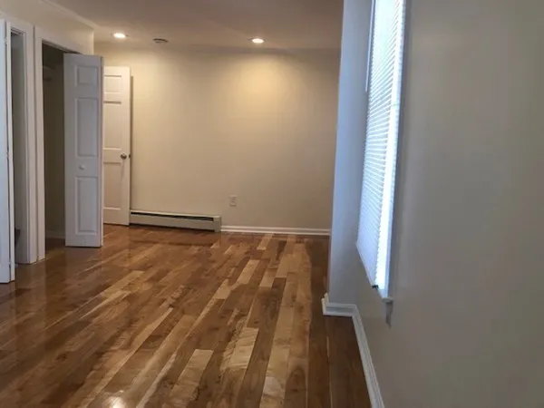 a view of hallway with wooden floor