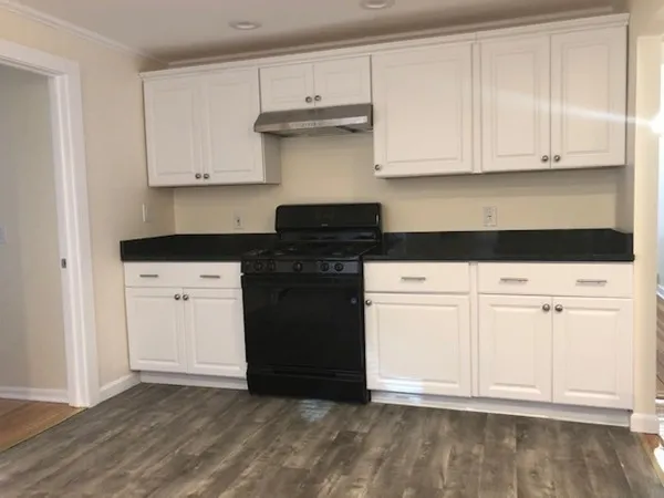 a kitchen with white cabinets and white appliances