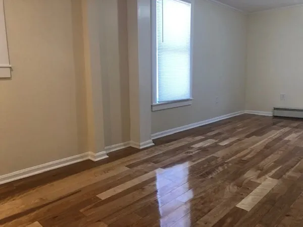 a view of wooden floor and windows in a room