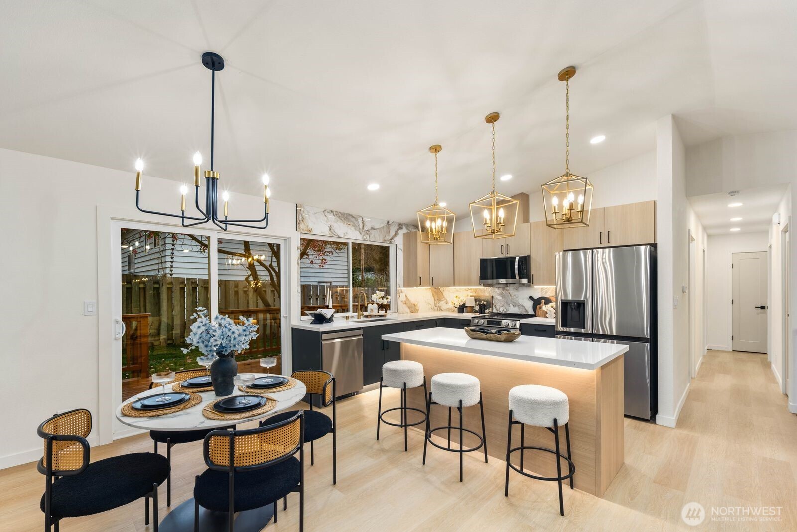 7211 182nd Street Southwest Edmonds, WA 98026 - Photo 14 of 40 a kitchen island with stainless steel appliances kitchen island granite countertop a table and chairs in it