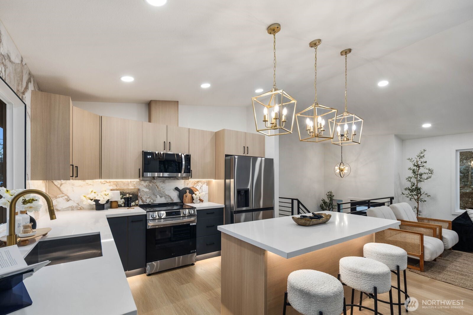 7211 182nd Street Southwest Edmonds, WA 98026 - Photo 20 of 40 a kitchen with stainless steel appliances granite countertop a sink a stove a kitchen island a dining table and chairs