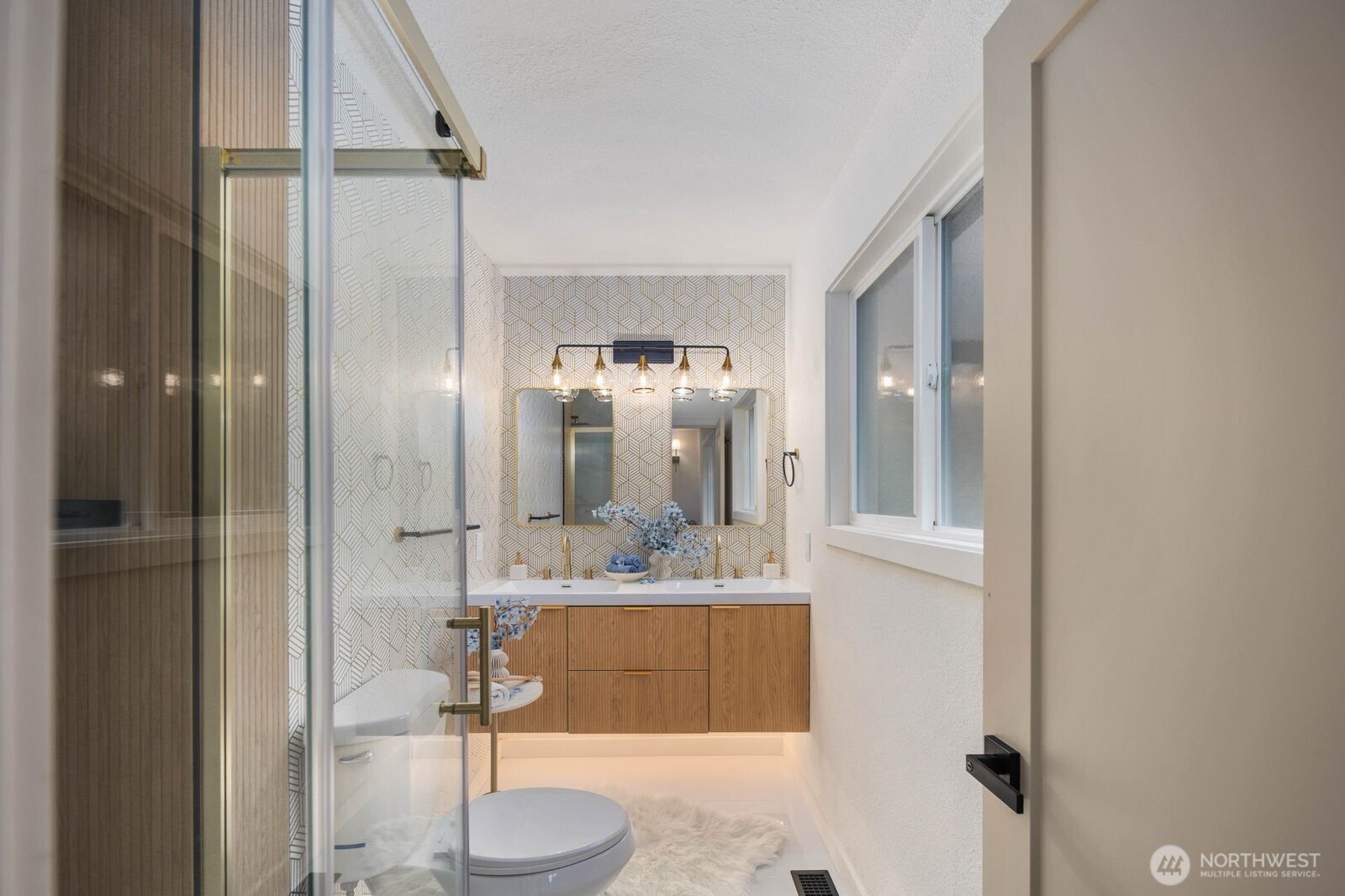 7211 182nd Street Southwest Edmonds, WA 98026 - Photo 26 of 40 a bathroom with a granite countertop sink a mirror and shower