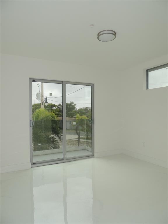 510 Foster Road, Unit 101 Hallandale Beach, FL 33009 - Photo 5 of 7 a view of an empty room with a window