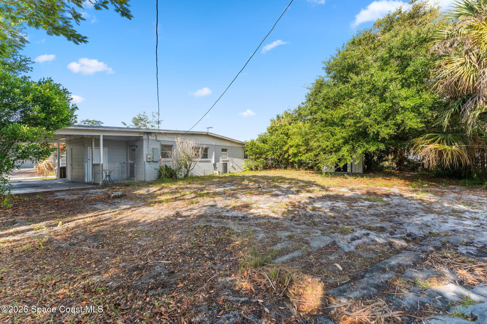 1042 Azalea Lane Cocoa, FL 32922 - Photo 23 of 26 a view of a house with backyard and a tree
