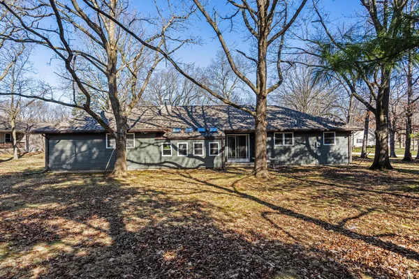 a view of a house with trees in the background