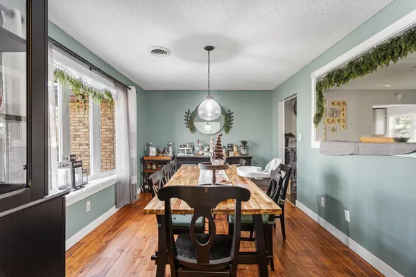 a view of a dining room with furniture window and wooden floor