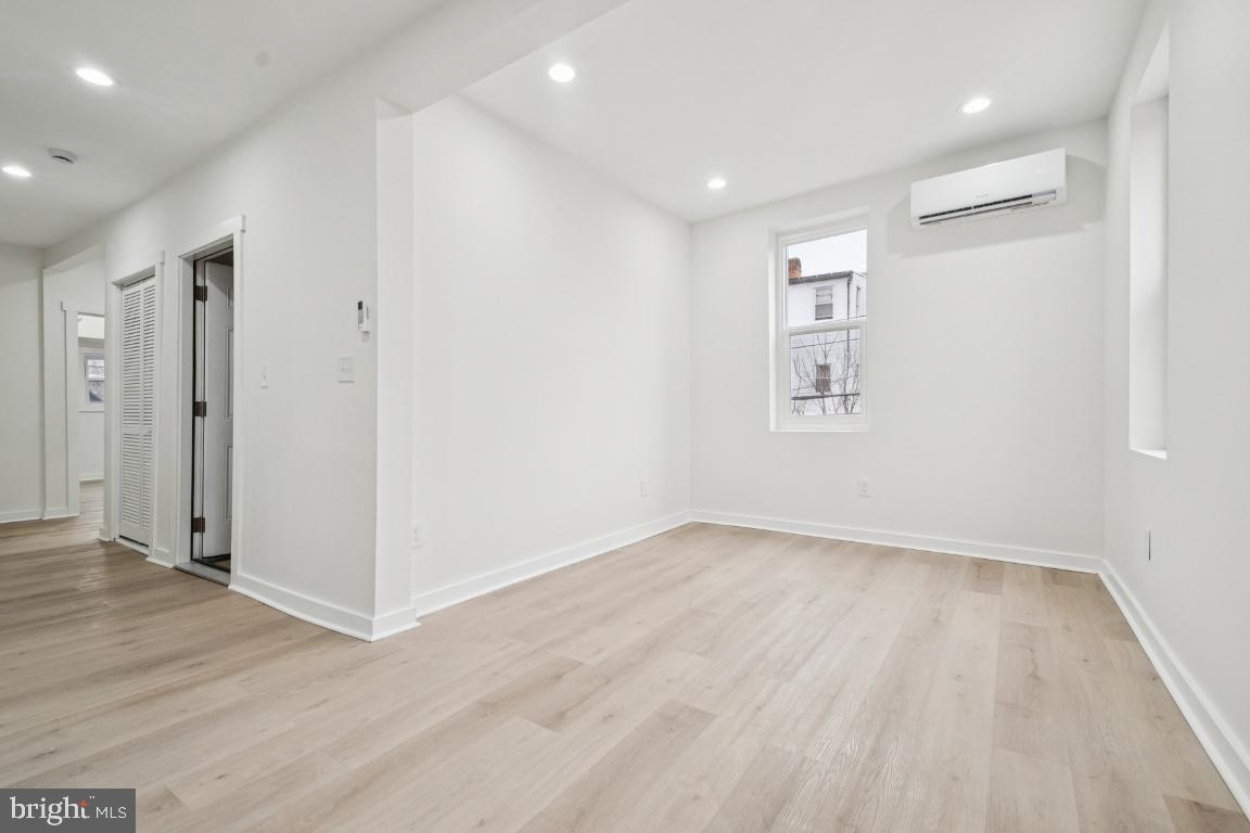 2330 Bryant Avenue Baltimore, MD 21217 - Photo 18 of 26 wooden floor in an empty room with a window
