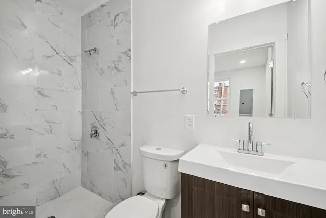 a bathroom with a sink toilet and shower