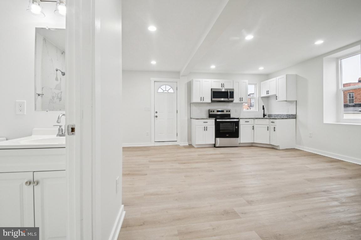 2330 Bryant Avenue Baltimore, MD 21217 - Photo 5 of 26 a view of an empty room and a kitchen