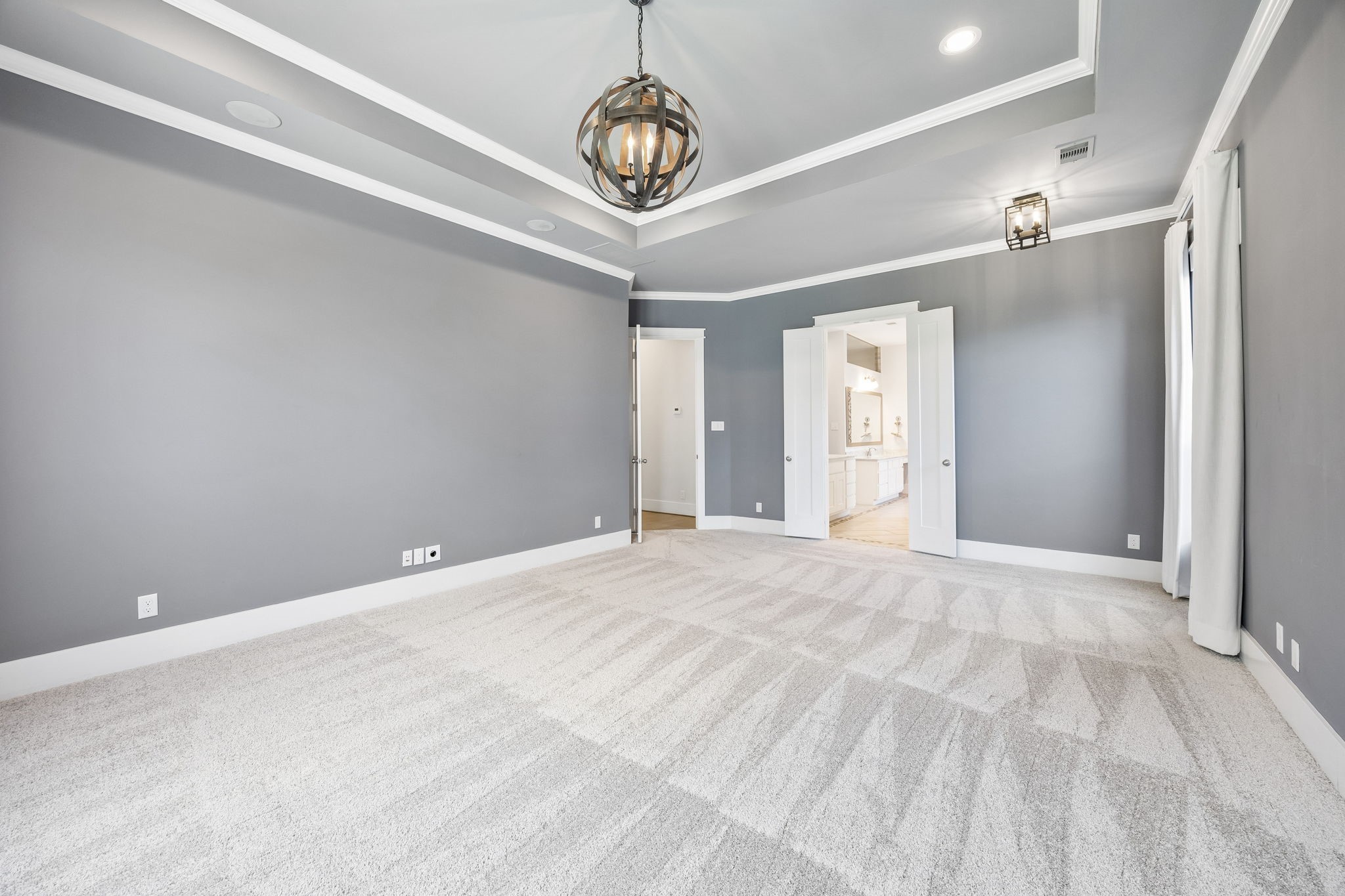 8558 Ridgepoint Drive Houston, TX 77055 - Photo 9 of 39 Layered ceiling details and contrasting white trim bring architectural definition to the primary bedroom, shown unfurnished.