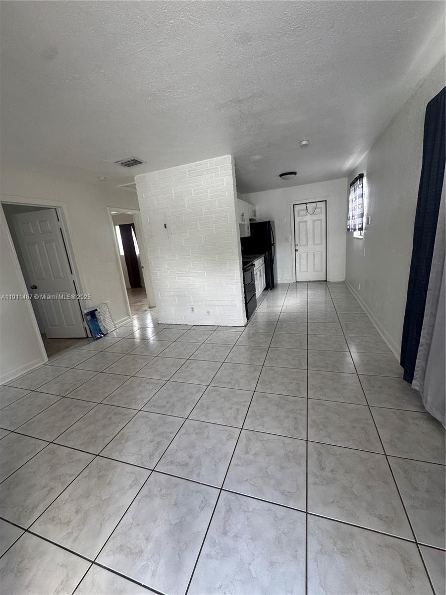 733 Northwest 4th Street, Unit 2 Hallandale Beach, FL 33009 - Photo 6 of 9 a view of a livingroom with furniture and window