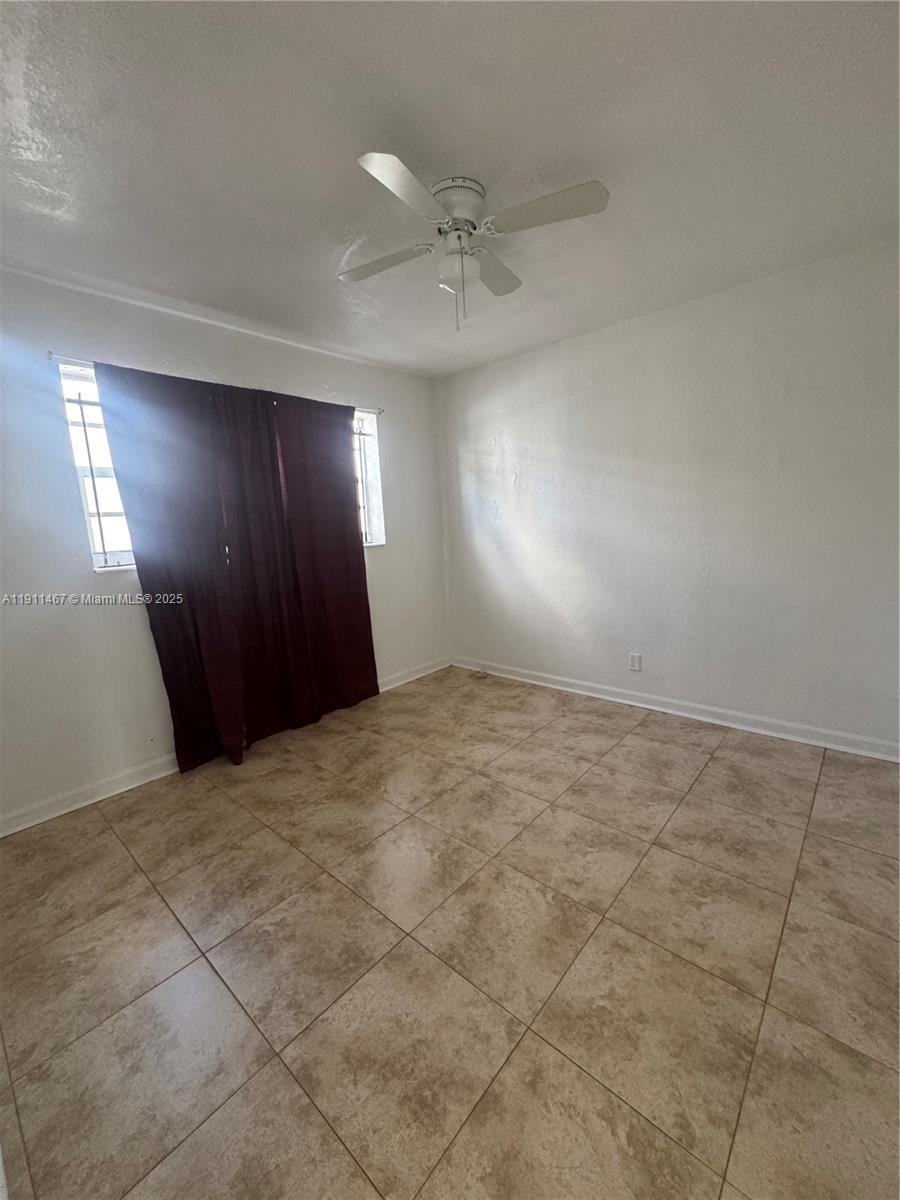 733 Northwest 4th Street, Unit 2 Hallandale Beach, FL 33009 - Photo 7 of 9 an empty room with a bathroom