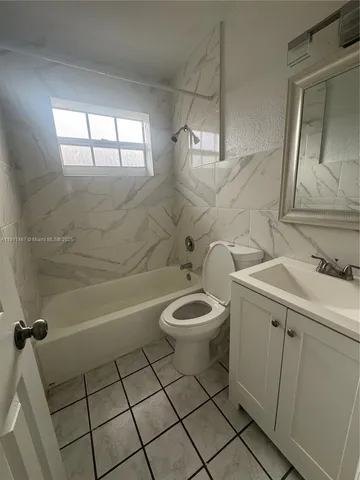 a bathroom with a toilet a sink and bathtub