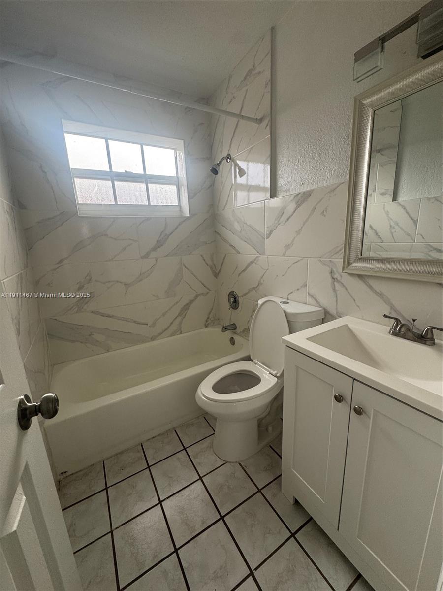 733 Northwest 4th Street, Unit 2 Hallandale Beach, FL 33009 - Photo 8 of 9 a bathroom with a toilet a sink and bathtub