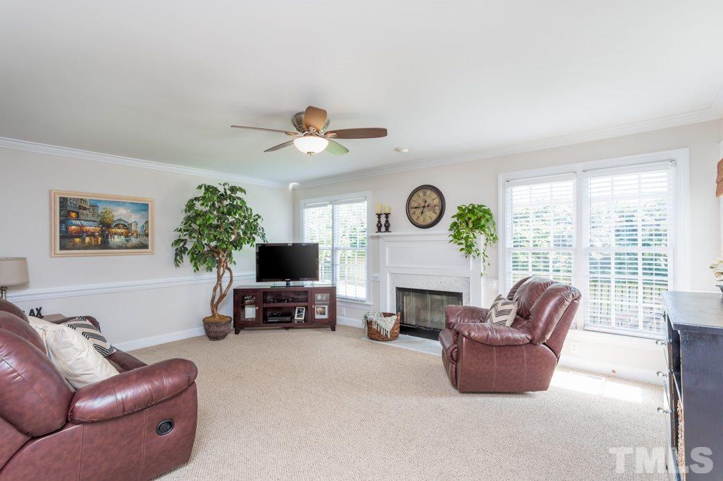 9232 Dawnshire Road Raleigh, NC 27615 - Photo 3 of 9 a living room with furniture a fireplace and a large window