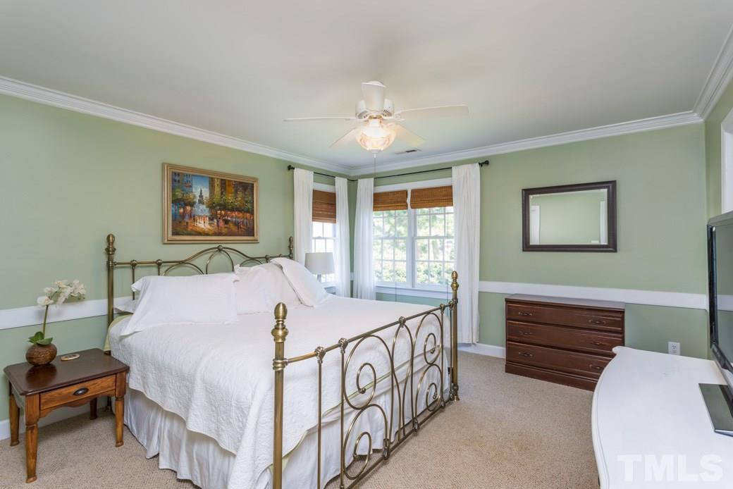 9232 Dawnshire Road Raleigh, NC 27615 - Photo 4 of 9 a bedroom with a bed and a chandelier