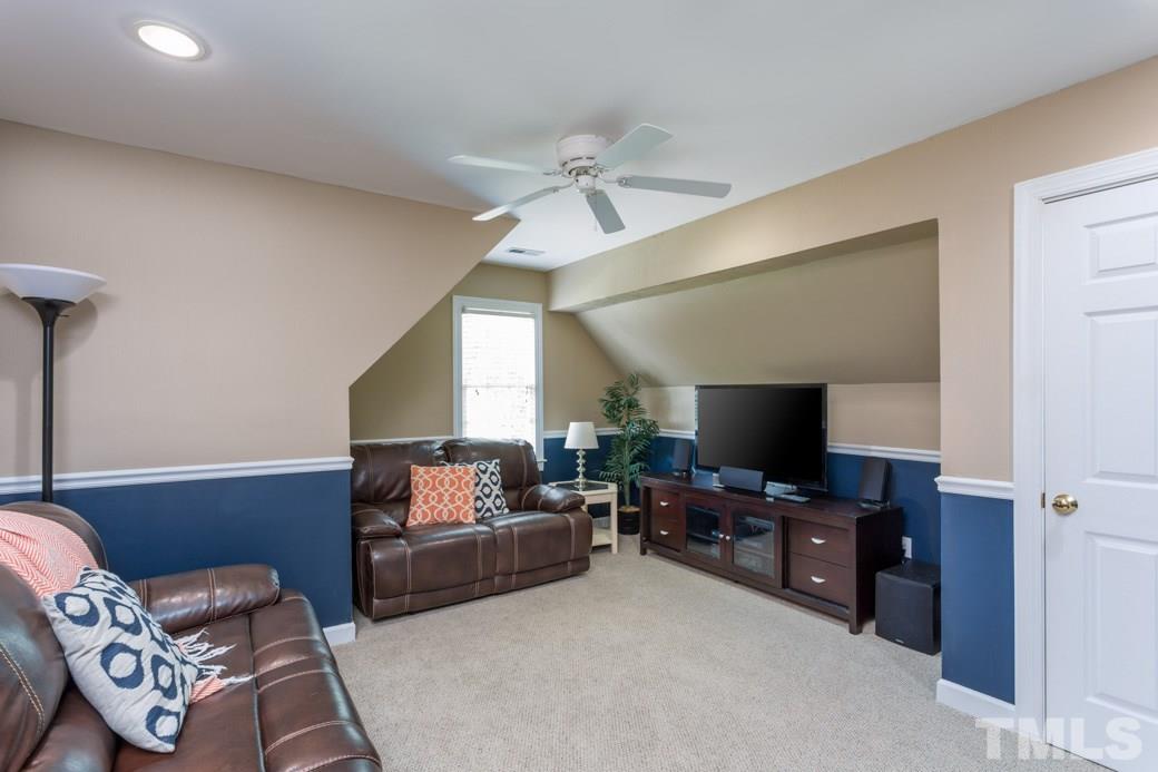 9232 Dawnshire Road Raleigh, NC 27615 - Photo 7 of 9 a living room with furniture and a flat screen tv