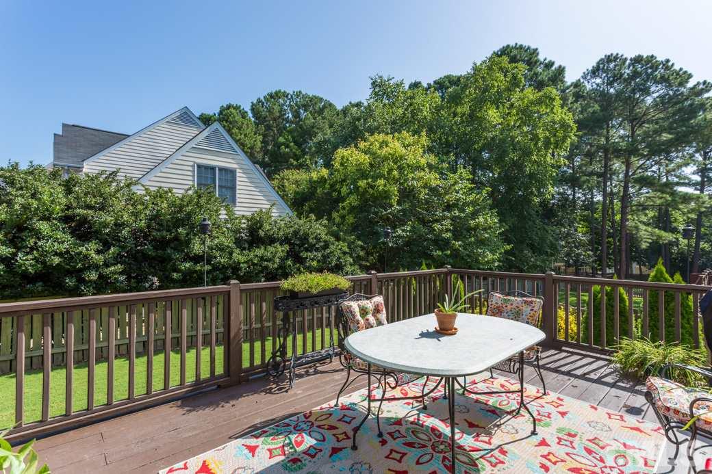 9232 Dawnshire Road Raleigh, NC 27615 - Photo 8 of 9 a balcony with a table and chairs
