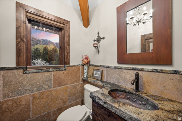 10280 Dimple Dell Road Sandy, UT 84092 - Photo 41 of 58 Bathroom with vanity, tile walls, wainscoting, and suspended lighting