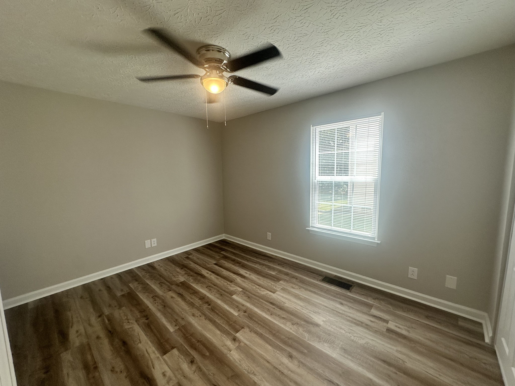 1506 Batts Boulevard, Unit 7 Springfield, TN 37172 - Photo 13 of 18 an empty room with a window and ceiling fan