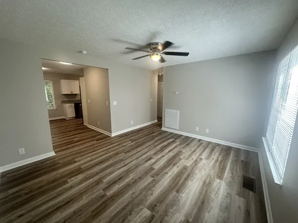 wooden floor in an empty room with a window
