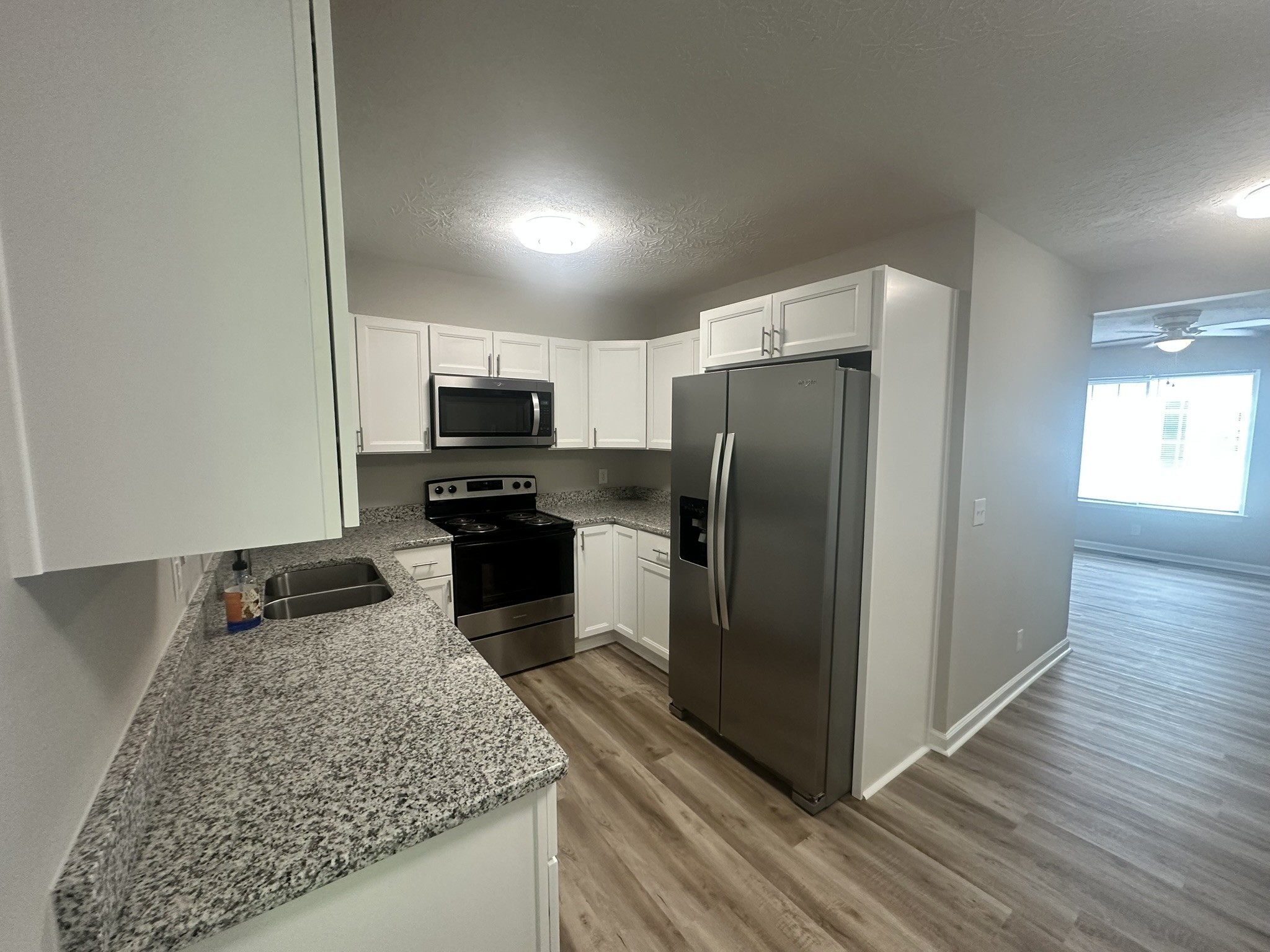1506 Batts Boulevard, Unit 7 Springfield, TN 37172 - Photo 4 of 18 a kitchen with granite countertop kitchen island wooden cabinets a refrigerator and a sink