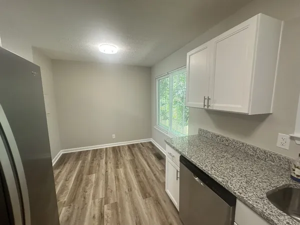 a kitchen with sink and cabinets