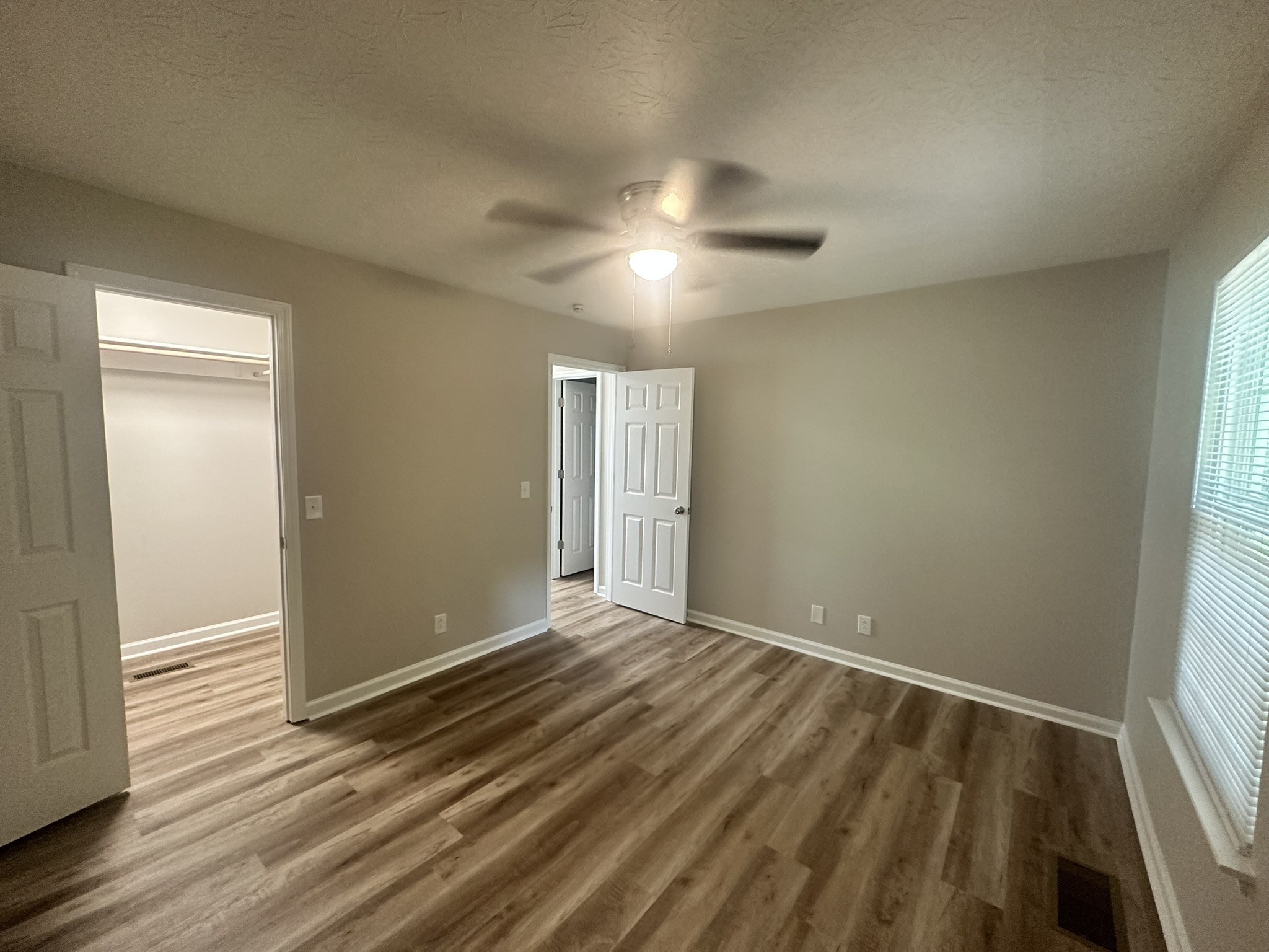 1506 Batts Boulevard, Unit 7 Springfield, TN 37172 - Photo 7 of 18 an empty room with wooden floor and windows