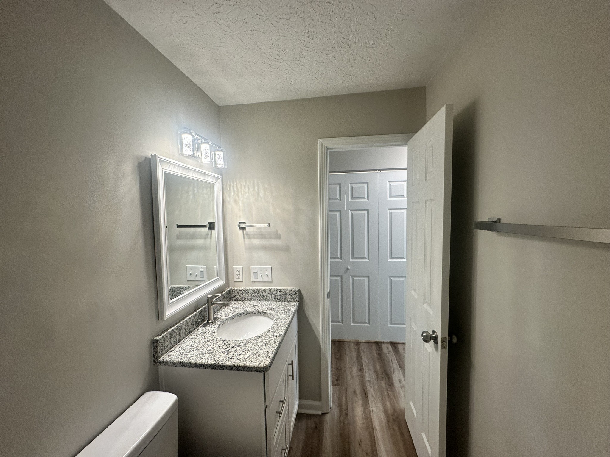 1506 Batts Boulevard, Unit 7 Springfield, TN 37172 - Photo 10 of 18 a bathroom with a granite countertop sink a mirror and a shower