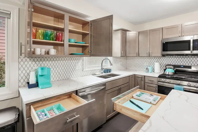 a kitchen that has a sink and a stove in it