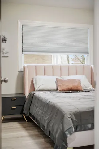 a bedroom with a bed and wall painting