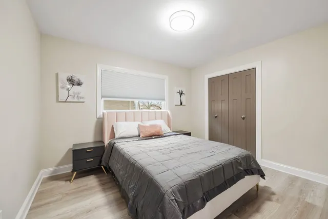 a bedroom with a bed and a window