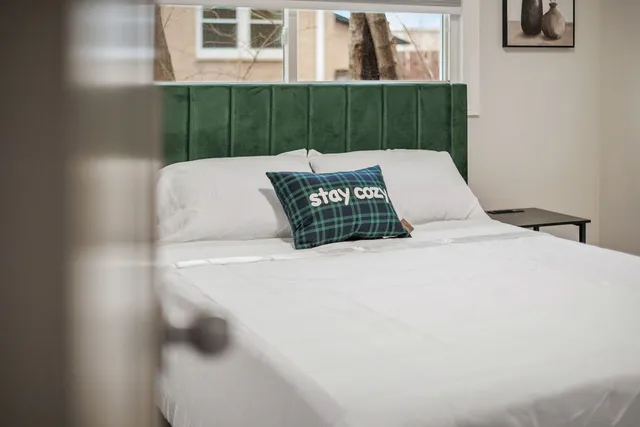 a bedroom with a bed and painting on the wall