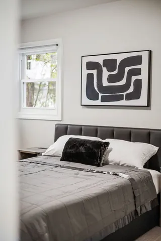 a bedroom with a bed and a window