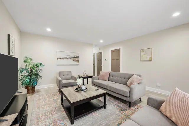 a living room with furniture potted plant and a window