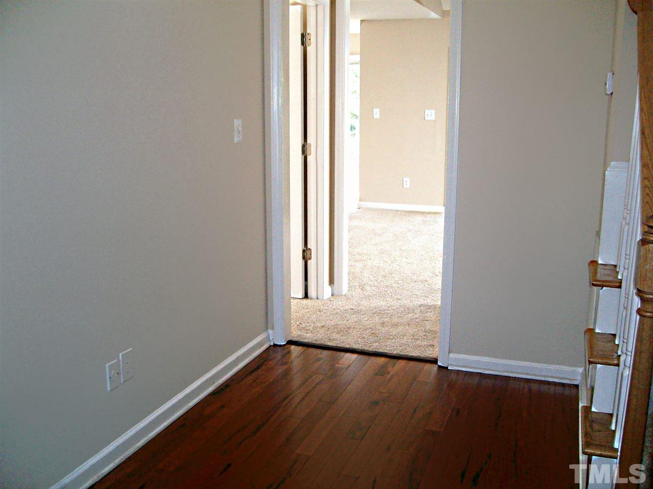 4717 Windbreak Lane Raleigh, NC 27616 - Photo 4 of 16 an empty room with wooden floor and windows
