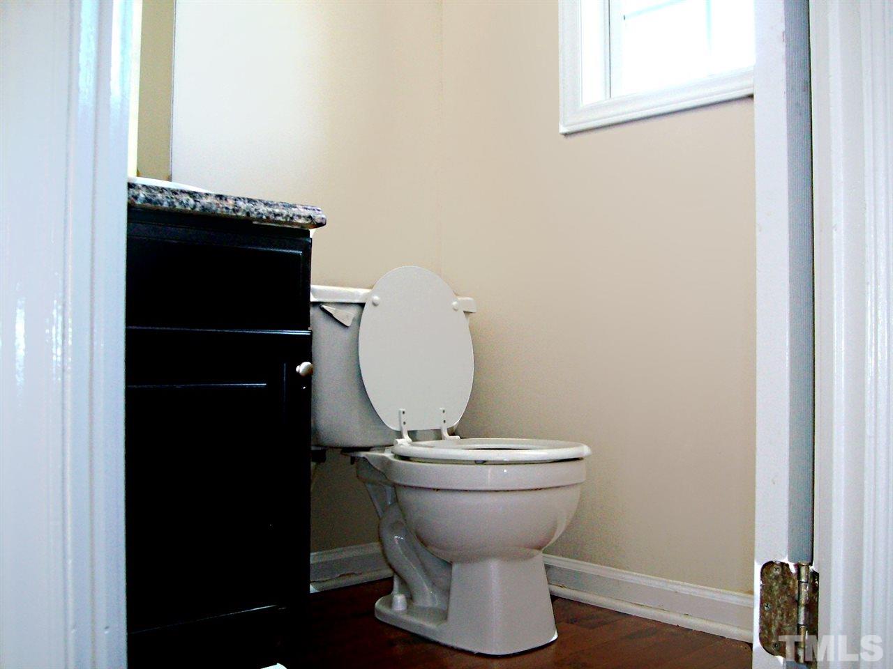 4717 Windbreak Lane Raleigh, NC 27616 - Photo 9 of 16 a view of a storage room with a sink and a mirror