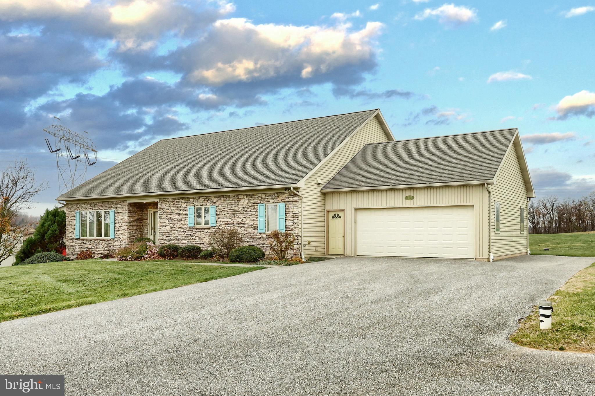a front view of house with yard and green space
