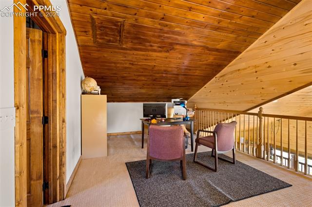 211 Yarnell Road Lake George, CO 80827 - Photo 20 of 50 Carpeted home office with lofted ceiling and wood ceiling