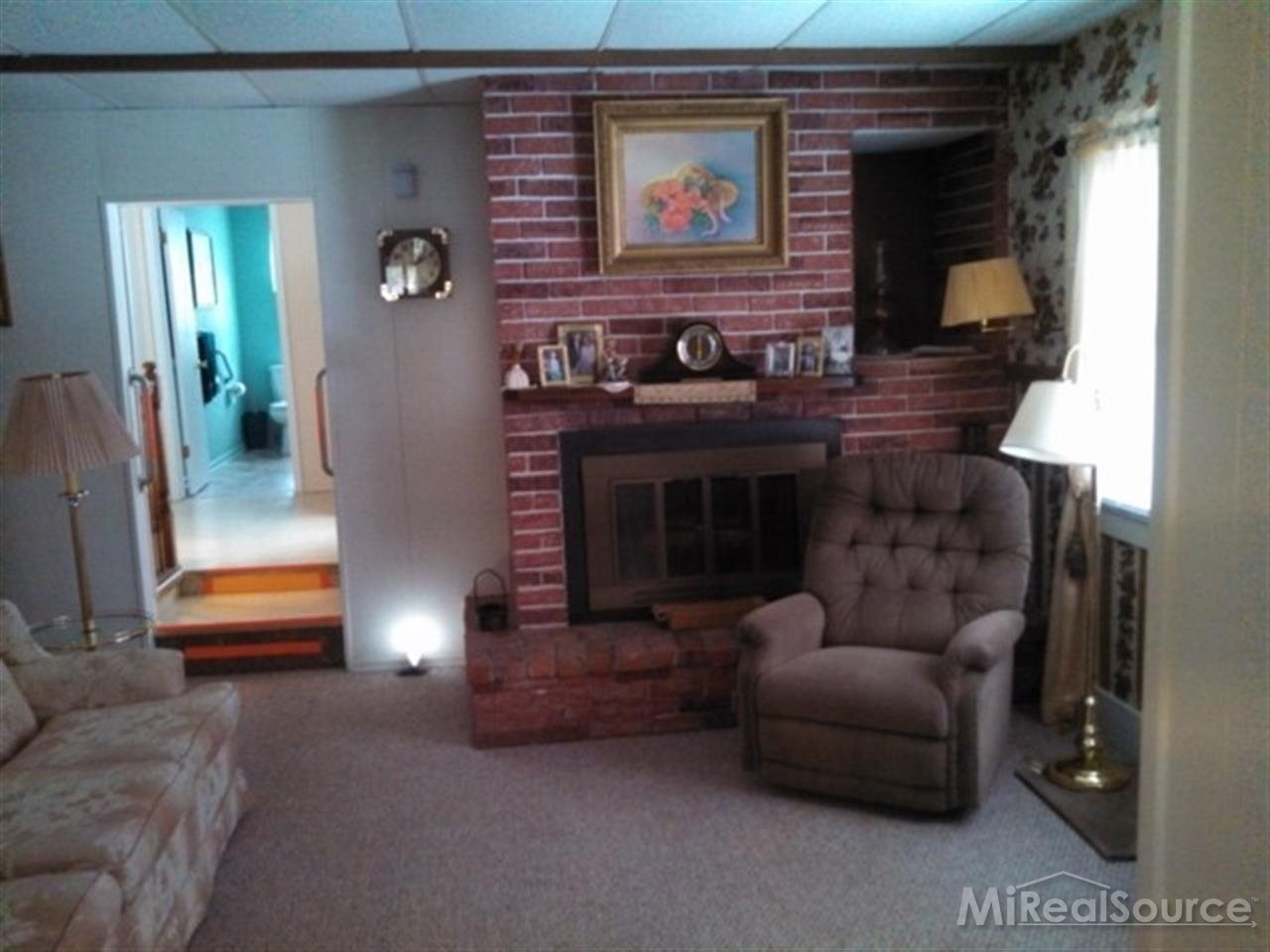 3028 Oneil Road Avoca, MI 48006 - Photo 5 of 17 This is another view of the living room that shows the fireplace.