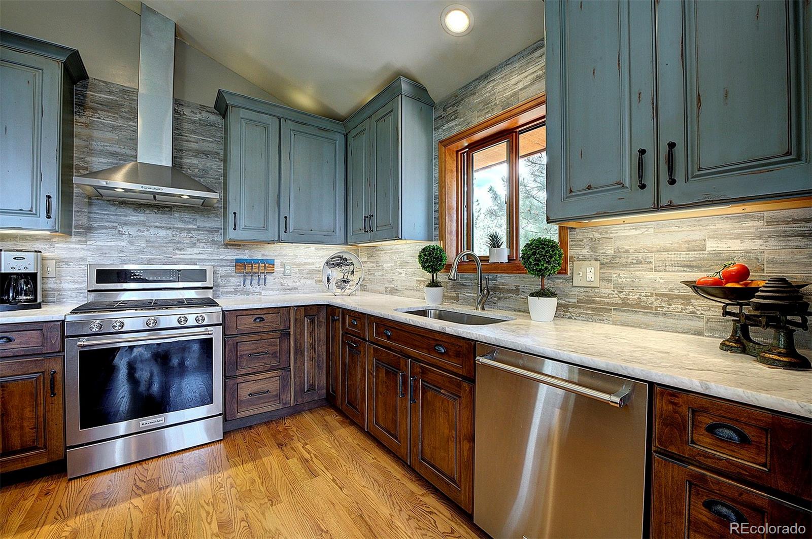29659 Spruce Road Evergreen, CO 80439 - Photo 12 of 38 a kitchen with stainless steel appliances granite countertop a sink stove and cabinets