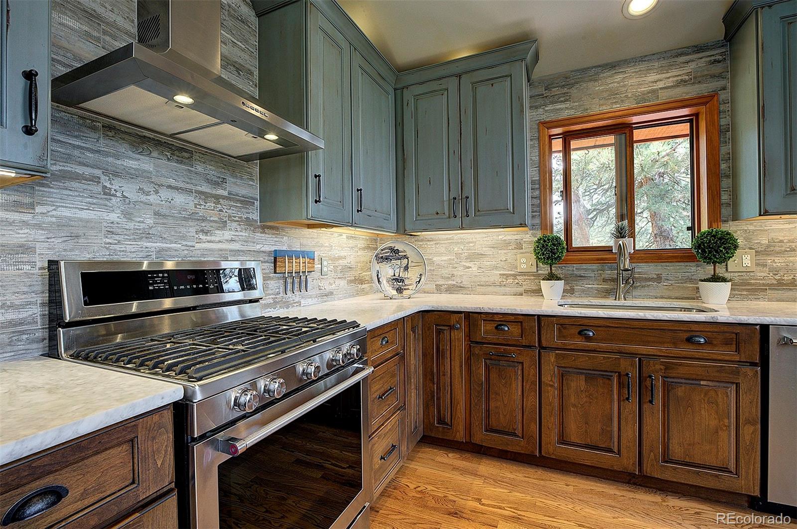 29659 Spruce Road Evergreen, CO 80439 - Photo 14 of 38 a kitchen with a stove and a sink