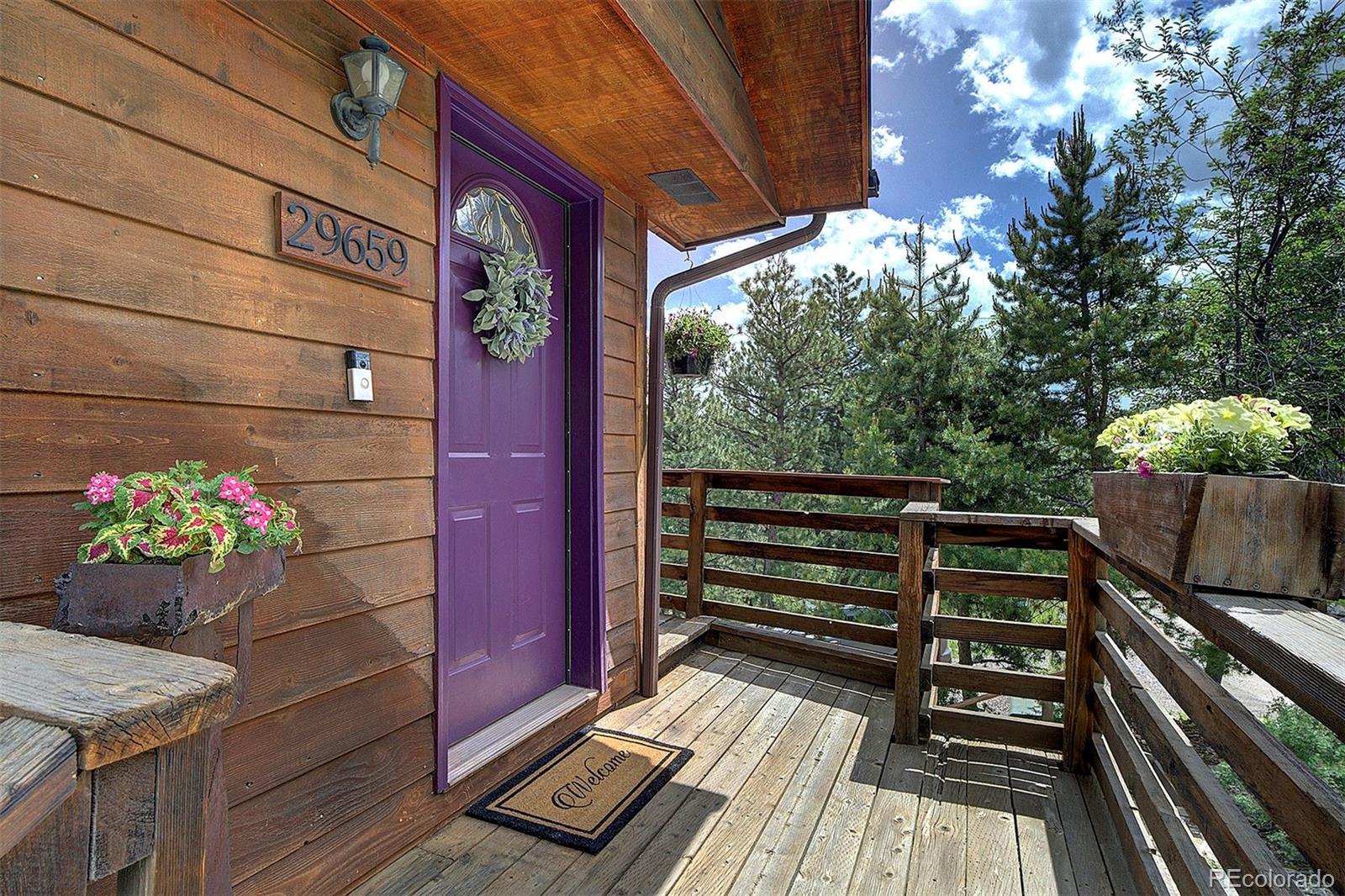 29659 Spruce Road Evergreen, CO 80439 - Photo 2 of 38 a view of a chairs and table in the balcony