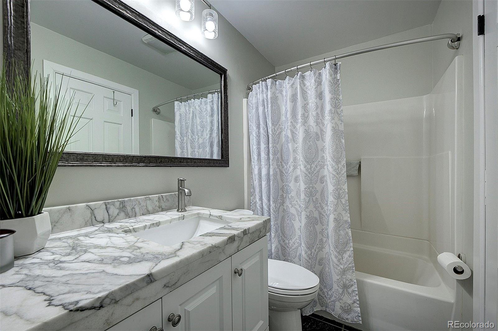 29659 Spruce Road Evergreen, CO 80439 - Photo 25 of 38 a bathroom with a granite countertop sink and a mirror