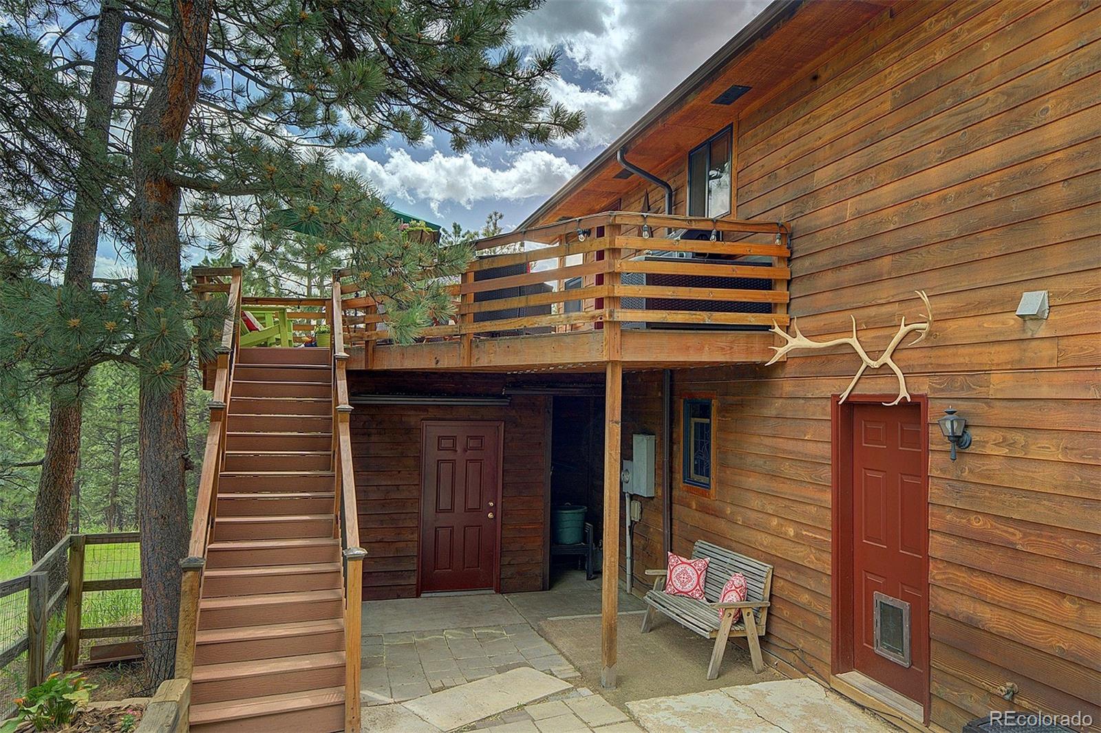29659 Spruce Road Evergreen, CO 80439 - Photo 36 of 38 a front view of a house with a door