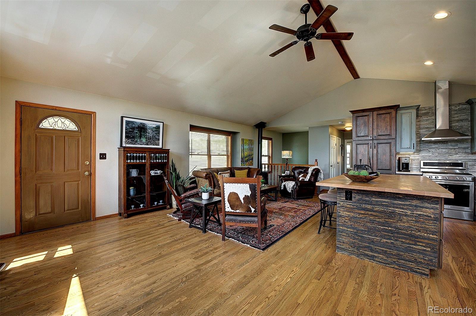 29659 Spruce Road Evergreen, CO 80439 - Photo 4 of 38 a living room with furniture and a wooden floor