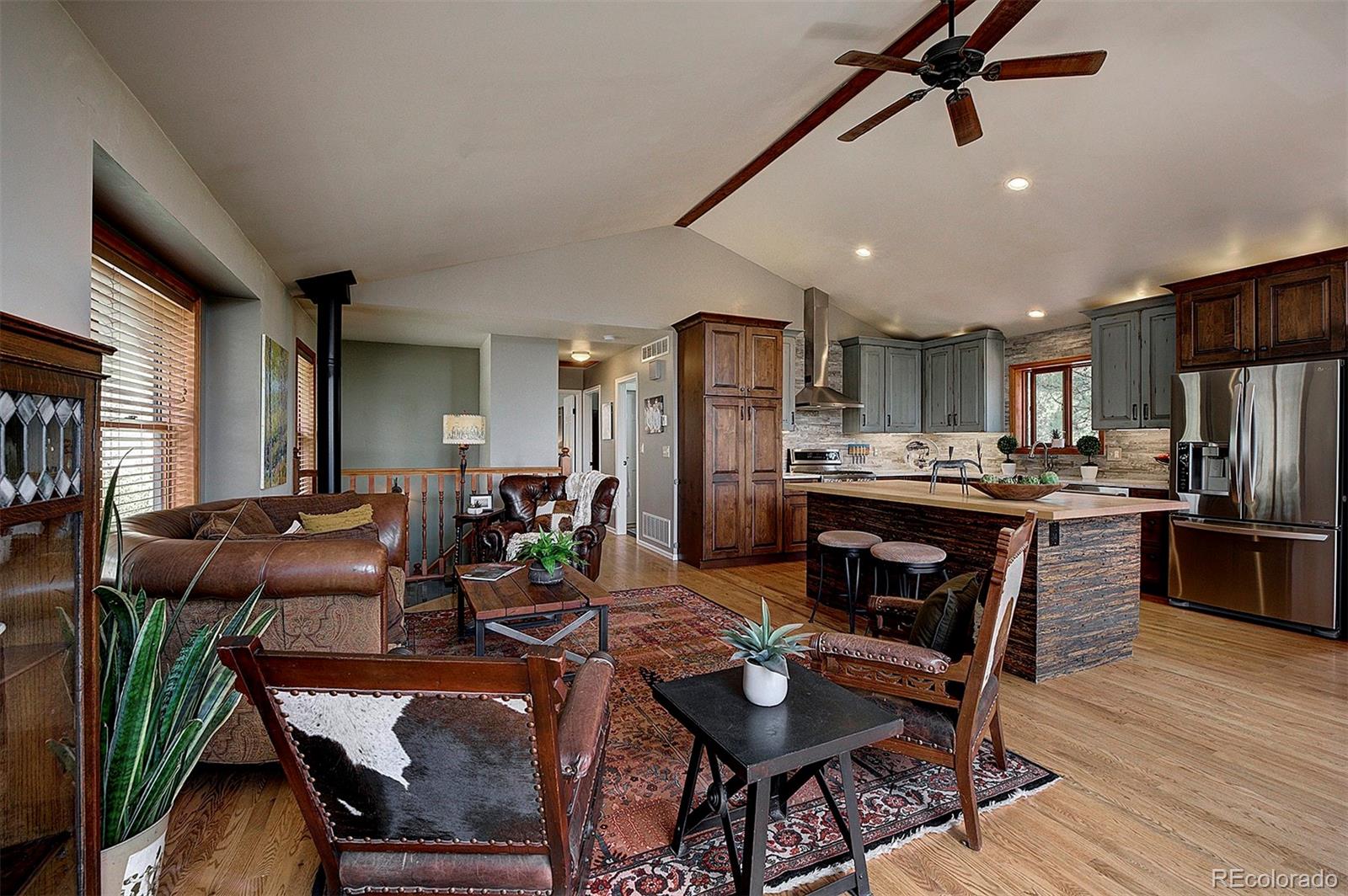 29659 Spruce Road Evergreen, CO 80439 - Photo 6 of 38 a view of a dining room with furniture window and wooden floor
